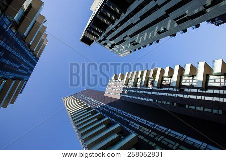 Milan, Italy, August 8 ,2016 - One Point Perspective Looking Straight Up Towards Clear Blue Sky From