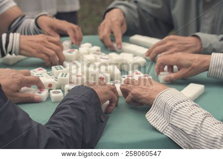 Mahjong Board Game. Playing Mahjong On Table. People Play A Board Game In The Park