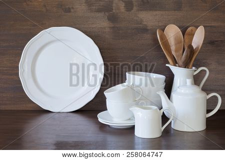 Crockery, Clayware, White Utensils And Other Different Stuff On Wooden Tabletop. Kitchen Still Life 