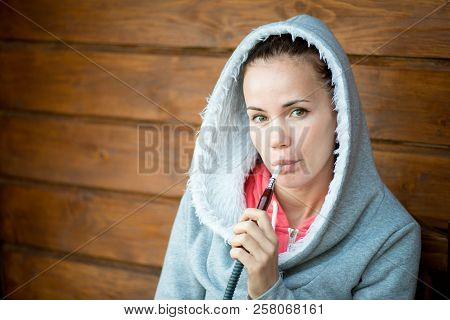 Sensual Young Girl Vaping Hookah Shisha Sitting On Terrace In Hotel. Vacation Rest. Lifestyle Withou