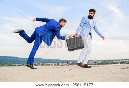 Risky Transaction. Businessman Takes Away Briefcase From Business Partner. Fraud And Extortion Conce