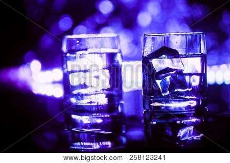 Colored Lighting Of Glasses In The Night Club Bar