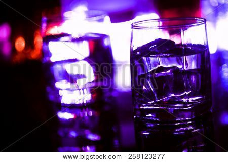 Colored Lighting Of Glasses In The Night Club Bar