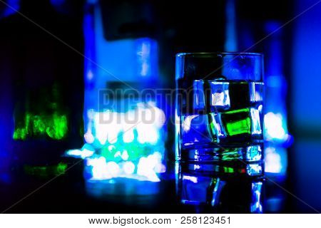 Colored Lighting Of Glasses In The Night Club Bar