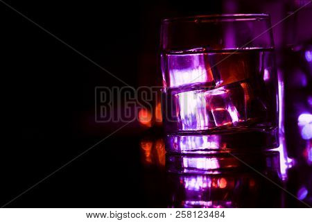 Colored Lighting Of Glasses In The Night Club Bar