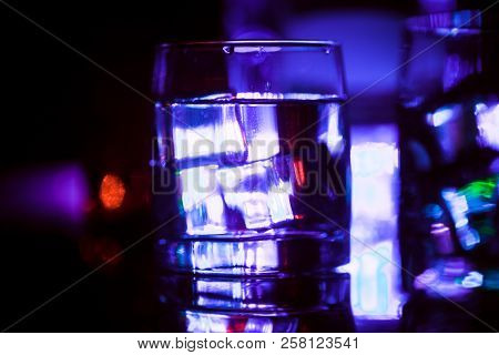 Colored Lighting Of Glasses In The Night Club Bar