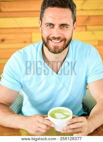 Man Bearded Guy Drinks Cappuccino At Wooden Table Cafe. Caffeine Can Get Creative Juices Flowing Whe
