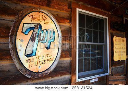 POLEBRIDGE, MONTANA, USA -  September 9, 2018: Vintage 7Up soda sign hangs on the exterior of Northern Lights Saloon
