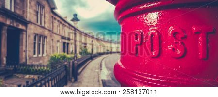 Panorama Of A Traditional British Red Post Box In A Curved Edwardian Terrace Street With Shallow Dep
