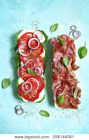 Italian Sandwith With Prosciutto Crudo, Mozzarella Cheese, Salame And Basil.top View With Copy Space