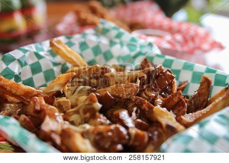 Fast Food Take Out Of Canadian Poutine With Cheese Melting Over French Fries With Beef Gravy In A Ba