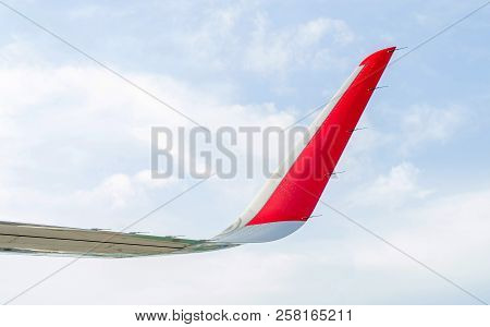 Close Up Of The Tip Of An Airplane Wing Against A Blue Sky