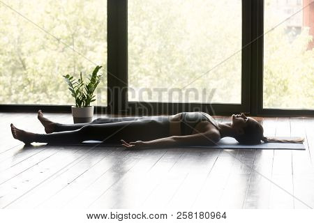 Young Sporty Attractive Woman In Dead Body Pose