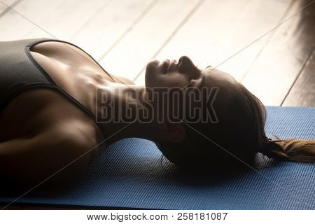 Young Sporty Attractive Woman In Corpse Pose, Close Up