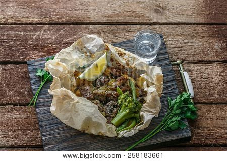 Lamb Kleftiko, Potato And Vegetables Served On Wooden Cutin Board, Rustic Style