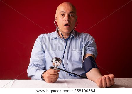 Hypertensive Patient Performing A Blood Pressure Auto Test / Man Self-monitoring Of Blood Pressure W
