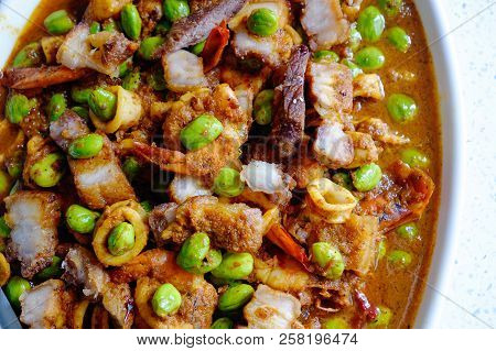 Stir-fried Twisted Cluster Bean With Shrimps/bitter Bean And Crispy Pork On A White Dish Over White 