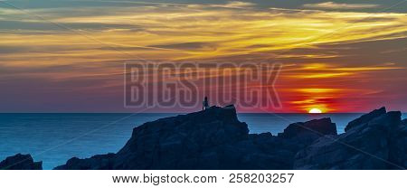 A Loan Figure Watches A Glorious Sunset At Hovs Hallar In Sweden.