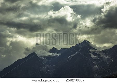 The Dark Sky Before A Storm In The Mountains With A Glacier