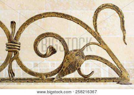 Wrought Iron Ornamental Grate For The Fireplace. Decorative Detail Of Metal Lattice For Interior.