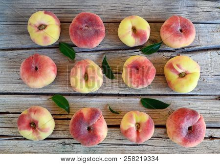 Chinese Flat Donut Peaches With Leaves On On Old Wooden Table Also Known As Saturn Donut,doughnut,pa