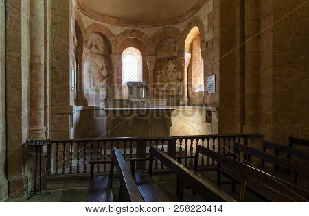 Gourdon, France - August 3, 2018: Interior With Pink Color, Wooden Benches And Huge Pilars Of The Ro