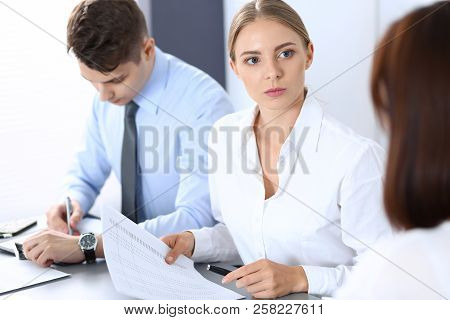 Group Of Business People Or Lawyers Discussing  Terms Of Transaction In Office. Meeting And Teamwork