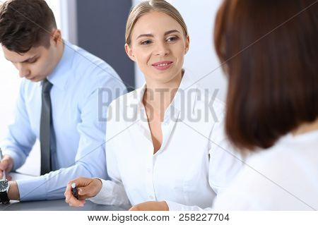 Group Of Business People Or Lawyers Discussing  Terms Of Transaction In Office. Meeting And Teamwork