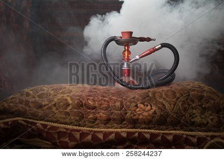 Hookah Hot Coals On Shisha Bowl Making Clouds Of Steam At Arabian Interior. Oriental Ornament On The