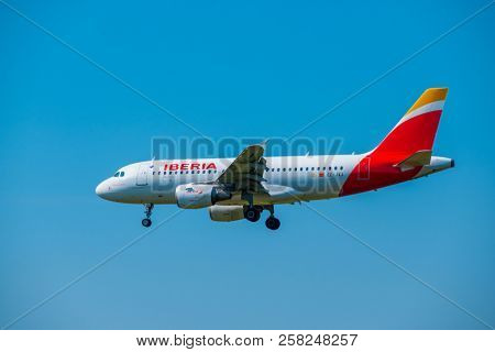 Zurich, Switzerland - July 19, 2018: Iberia airlines airplane preparing for landing at day time in Zurich nternational airport