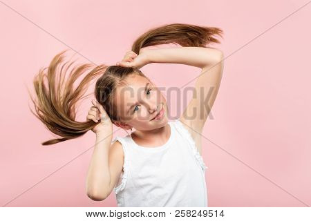 Happy Joyful Smiling Adolescent Girl Making Pig Tails From Her Hair. Relaxed Carefree Lifestyle And 