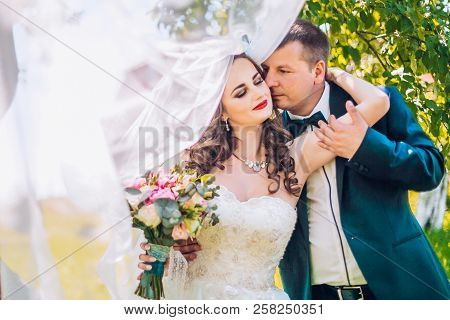 Marriage Concept. Bride And Groom Kissing Outdoor. Newlyweds Couple In Love. Wedding Couple In Love 