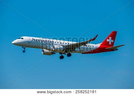 Zurich, Switzerland - July 19, 2018: Helvetic Swiss airlines airplane preparing for landing at day time in international airport