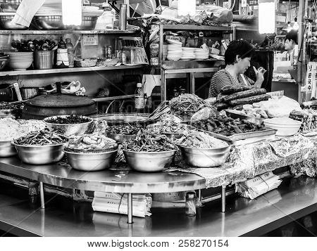 Seoul, South Korea - June 21, 2017: Woman Vendor Serving Customers At Gwangjang Market In Seoul.