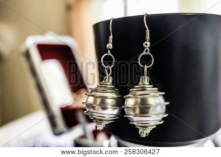 Silvery Pearl Earrings With Steel Spiral Handmade. Sterling Silver Schwanz. Limited Depth Of Field.