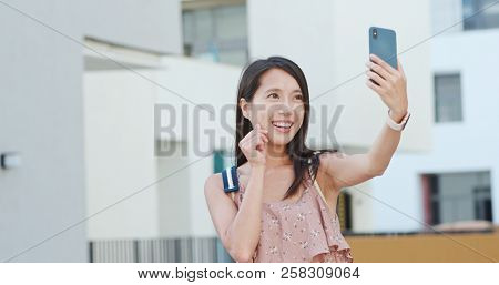Woman taking vlog on cellphone in Shum Yip upperhills