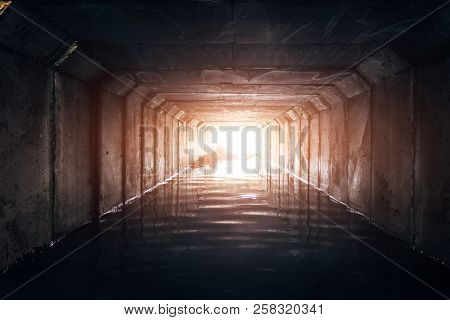 Light At The End Of Dark Flooded Sewer Tunnel.