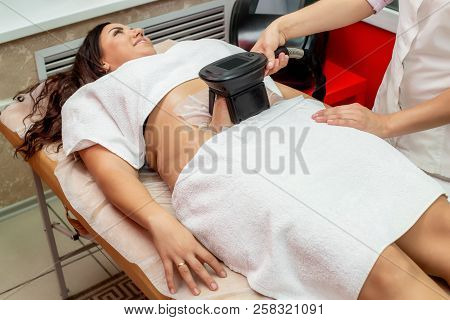 Woman Getting Cryolipolysis Fat Treatment Procedure In Professional Cosmetic Cabinet Or Spa Center