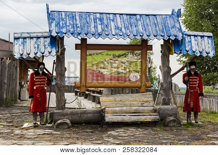 Mannequins Of Archers In Red Caftans With Axes In Hands
