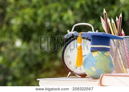 Graduate Or Education Knowledge Study Abroad Concept : Graduation Cap On Textbook With Pencil Box An