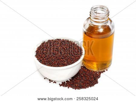 Mustard Seeds With Essential Oil On White Background