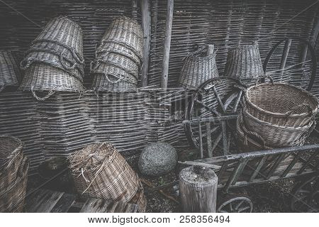 Weave Baskets Workshop Stacked In A Wooden Cabin With Old Wheels And Ladders
