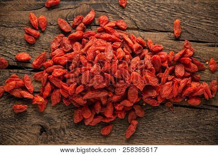 Dried Fruits Of Goji Berries Or Wolfberry On Rustic Wooden Table