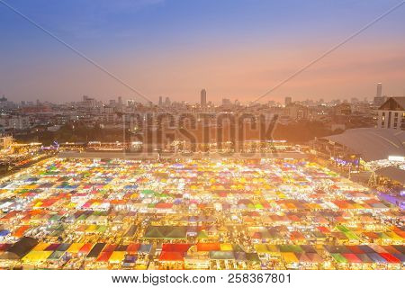 Night Light Aerial View Flea Market With City Downtown Background