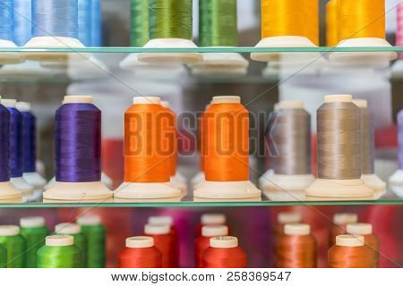 Colorful Embroidery Thread Spool Using In Garment Industry, Row Of Multicolored Yarn Rolls, Sewing M