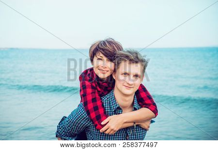 Portraits Of Happy Romantic Couple On The Sea Beach Embracing Each Other. Concept Of Lovers Happy Mo