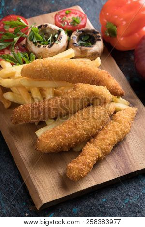 Deep fried chicken frites with potato chips or french fries