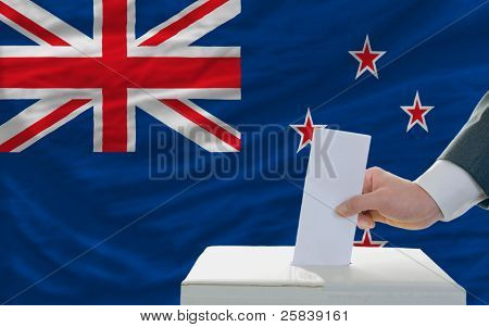 Man Voting On Elections In New Zealand In Front Of Flag
