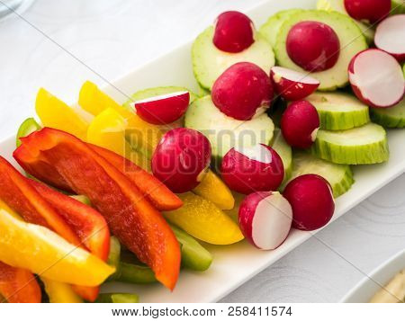 Close Up Of A Plate With Mixed Fresh Vegetables: Redish, Paprika, Cucumber