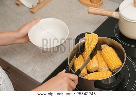 Woman Preparing Corn In Stewpot On Stove, Closeup